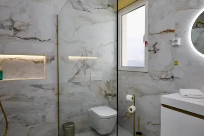 a bathroom with a toilet and a sink and a window at Quinta dos Cardais by AnaLodges in São Vicente