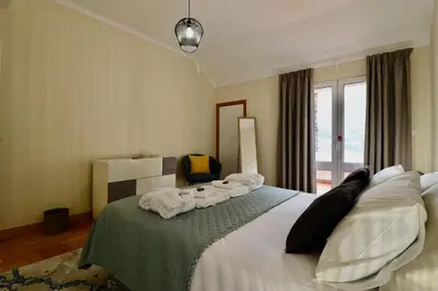 a hotel room with a bed with towels on it at Quinta dos Cardais by AnaLodges in São Vicente