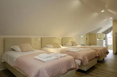 a bedroom with three beds with towels on them at Quinta dos Cardais by AnaLodges in São Vicente