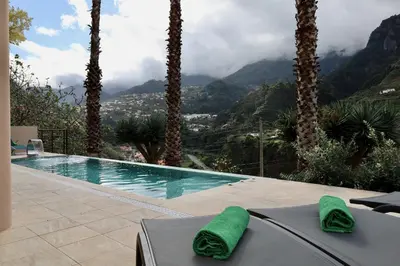 a swimming pool with a view of a mountain at Quinta dos Cardais by AnaLodges in São Vicente