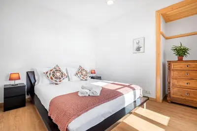 a bedroom with a bed with two towels on it at Casa os Gauleses in Gaula