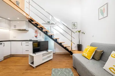a living room with a couch and a staircase at Casa os Gauleses in Gaula