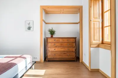 a bedroom with a bed and a dresser with a plant on it at Casa os Gauleses in Gaula