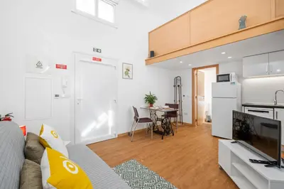 a living room with a couch and a kitchen at Casa os Gauleses in Gaula