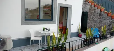 a balcony with a table and chairs and plants at Vista Funchal Ⅰ in Funchal