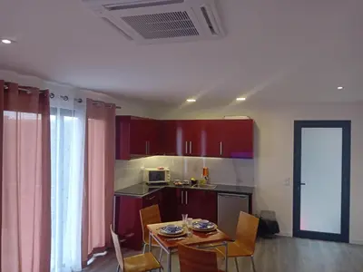 a kitchen with a table and chairs in a room at Vista Funchal Ⅰ in Funchal