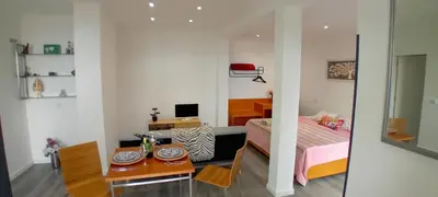 a bedroom with a bed and a table and a desk at Vista Funchal Ⅰ in Funchal