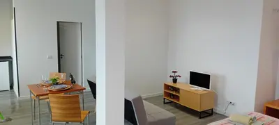 a living room with a table and a tv at Vista Funchal Ⅰ in Funchal