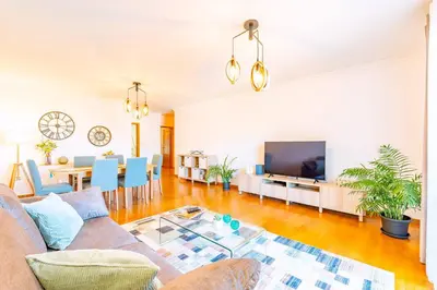 a living room with a couch and a tv at Serene Haven Retreat - Madeira Island in Caniço
