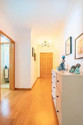 a large room with a wooden floor and white walls at Serene Haven Retreat - Madeira Island in Caniço