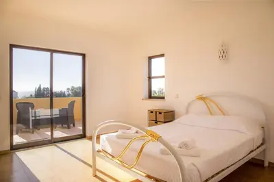 a white bedroom with a bed and a balcony at D05 - Amadeus Sunset Villa in Mato Porcas