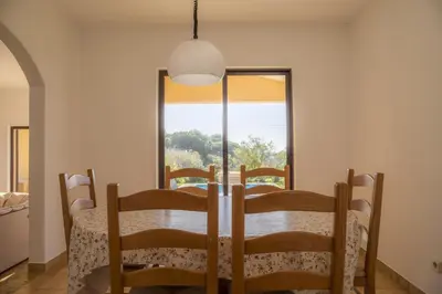 a dining room with a table and a window at D05 - Amadeus Sunset Villa in Mato Porcas