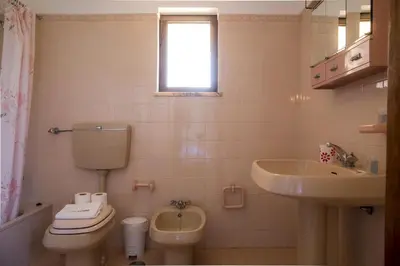 a bathroom with a toilet and a sink at D05 - Amadeus Sunset Villa in Mato Porcas