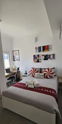 a bedroom with a bed with a dresser and a window at Beach & House''Villa Maria'' 5 min to Mareta Beach in Sagres