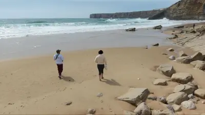 a view of a beach through a rock cave at Beach & House''Villa Maria'' 5 min to Mareta Beach in Sagres