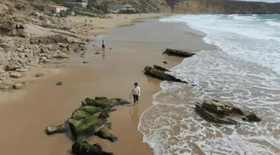 a row of chairs and umbrellas on a beach at Beach & House''Villa Maria'' 5 min to Mareta Beach in Sagres