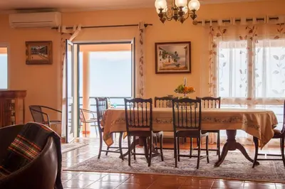 a dining room with a table and chairs at Quinta do Santo by LovelyStay in Santo da Serra