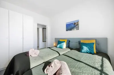 two beds sitting next to each other in a bedroom at Casinha in Burgau