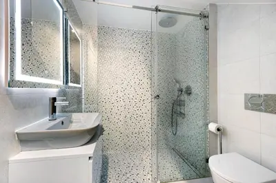 a bathroom with a shower with a sink and a toilet at Casinha in Burgau