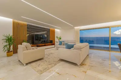 a living room with two chairs and a large window at Lê Maison Deluxe Madeira - Where Peace is breathed and Luxury is felt! in Ribeira Brava