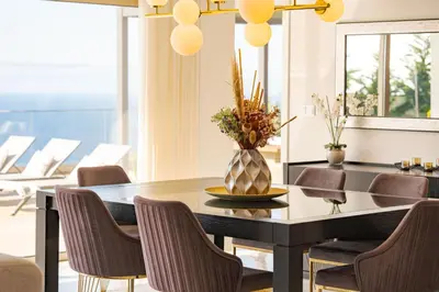a dining room with a table and chairs at Lê Maison Deluxe Madeira - Where Peace is breathed and Luxury is felt! in Ribeira Brava