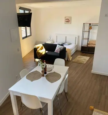a living room with a white table and a couch at Machico center w/ terrace 5 min beach in Machico
