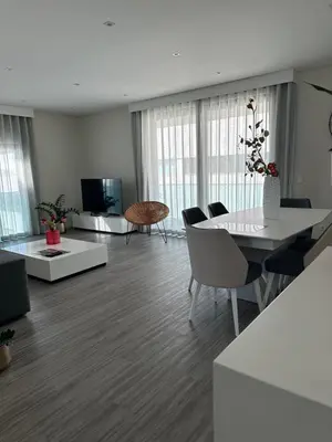 a living room with a table and chairs and a television at Raphael Funchal Views Apartment in Funchal