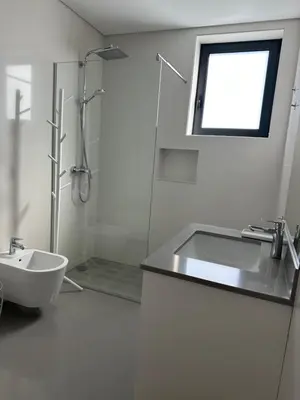 a white bathroom with a sink and a shower at Raphael Funchal Views Apartment in Funchal