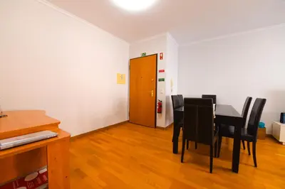 a dining room with a table and black chairs at Farinha's Apartment in Ribeira Brava