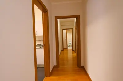 a hallway with two doors leading into a room at Farinha's Apartment in Ribeira Brava