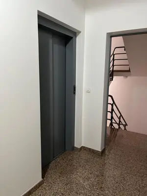 an open door in a room with a staircase at Farinha's Apartment in Ribeira Brava