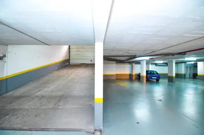 an empty parking garage with a car parked in it at Farinha's Apartment in Ribeira Brava