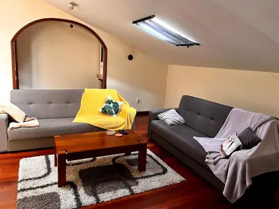 a living room with a couch and a table at Casa Câmara in Arco da Calheta