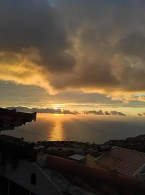 a view of the ocean with the sun setting at Casa Câmara in Arco da Calheta