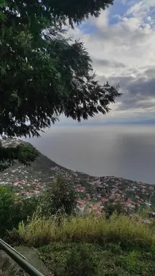 a view of a town on a hill with the ocean at Casa Câmara in Arco da Calheta