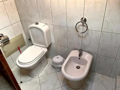 a small bathroom with a toilet and a bidet at Casa Câmara in Arco da Calheta