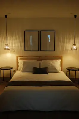 a bedroom with a large white bed with two lights at CASA15 Guesthouse Funchal in Funchal