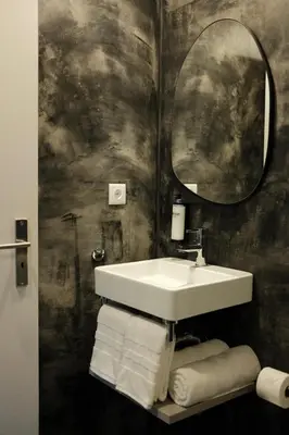 a bathroom with a sink and a mirror and towels at CASA15 Guesthouse Funchal in Funchal