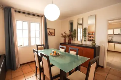 a kitchen and dining room with a table and chairs at Villa Margarida in Ponta do Sol