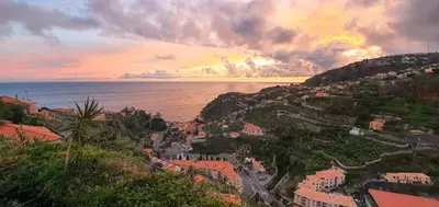 a view of a town on a hill next to the ocean at Villa Margarida in Ponta do Sol