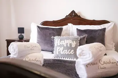 a bed with pillows with the words happy place on it at Casa Monte by GALMI in Funchal