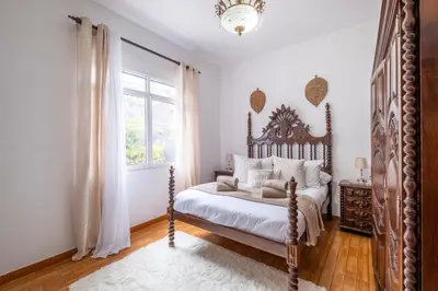 a bedroom with a large bed and a window at Casa Monte by GALMI in Funchal