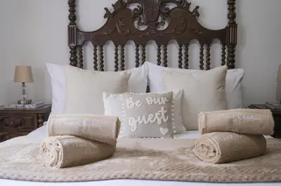 a bed with pillows and a headboard with two pillows at Casa Monte by GALMI in Funchal