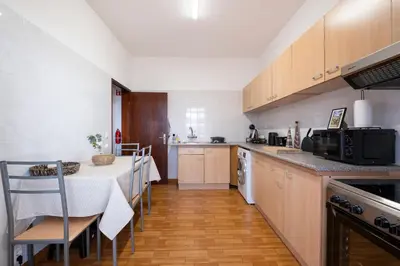 a kitchen with a table and chairs and a counter top at Casa Monte by GALMI in Funchal