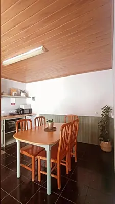 an outdoor patio with a couch and a table at Kanela Guest House in Machico