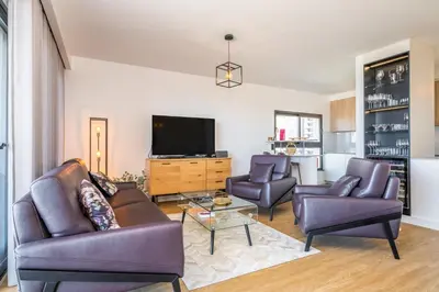 a living room with two couches and a tv at SkyView Penthouse Apartment by MHM in Funchal