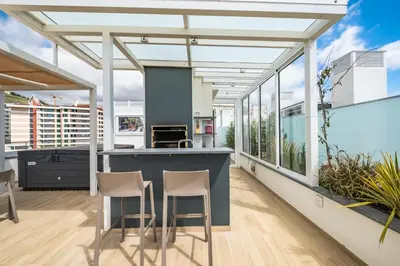 an open kitchen with a blue counter and stools at SkyView Penthouse Apartment by MHM in Funchal
