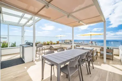a dining room with a table and views of the ocean at SkyView Penthouse Apartment by MHM in Funchal