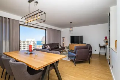 a living room with a table and chairs and a view at SkyView Penthouse Apartment by MHM in Funchal
