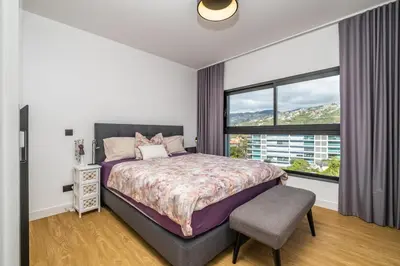 a bedroom with a bed and a large window at SkyView Penthouse Apartment by MHM in Funchal